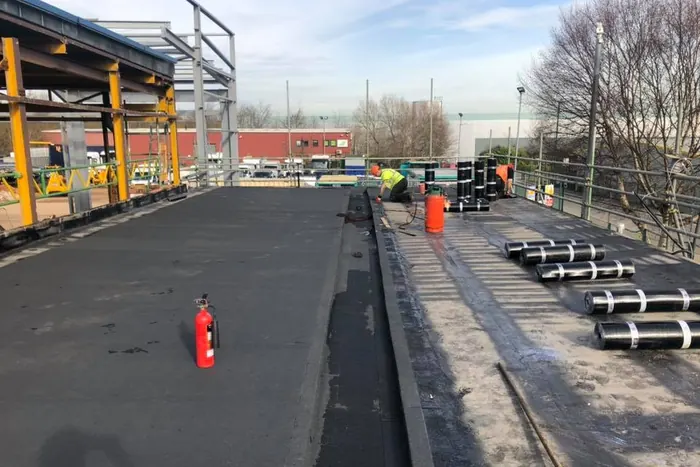 Large commercial felt roof in Mansfield — Offset roof with multiple outlets and mechanical plant